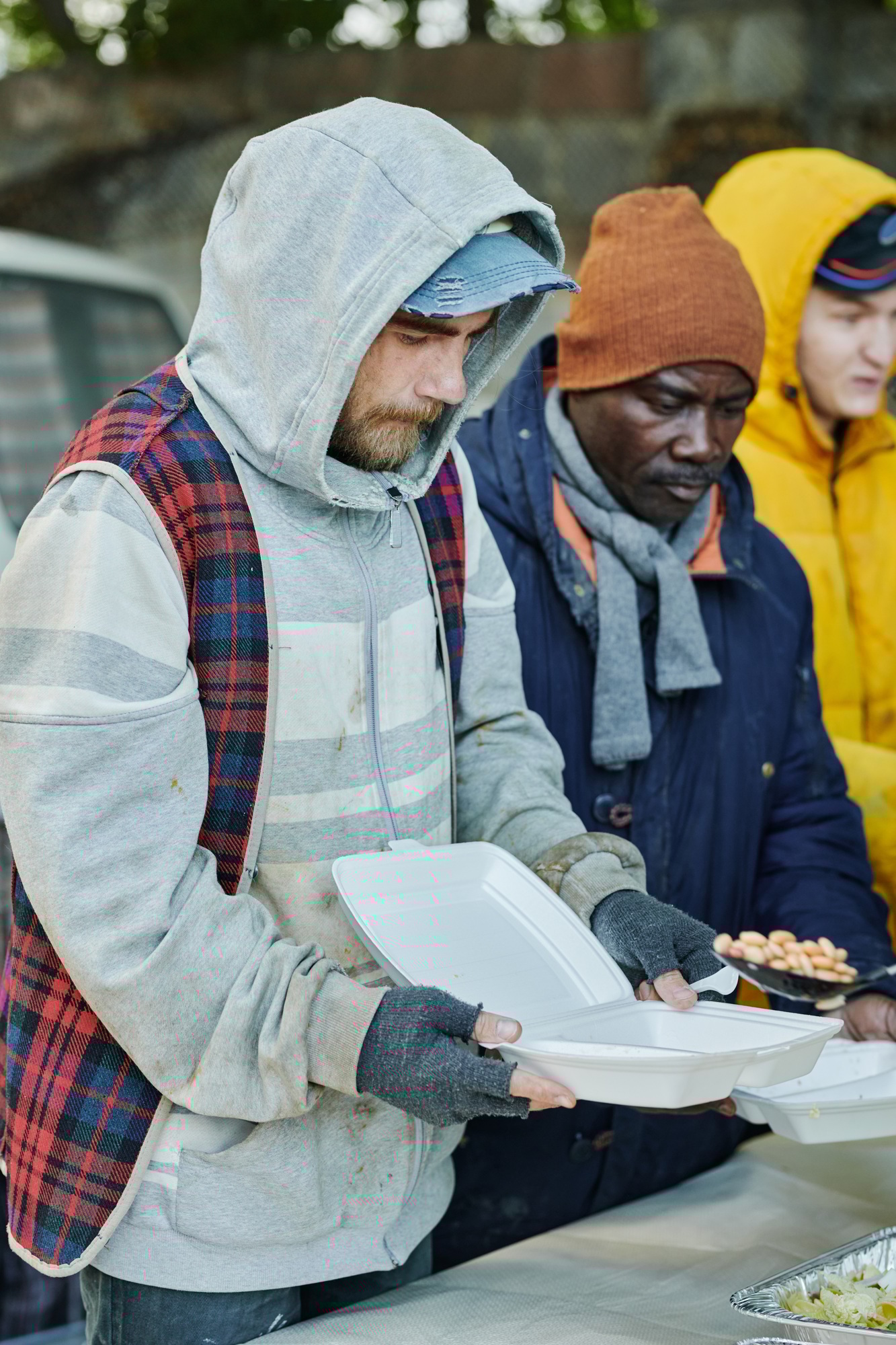 Homeless people feeding by volunteers