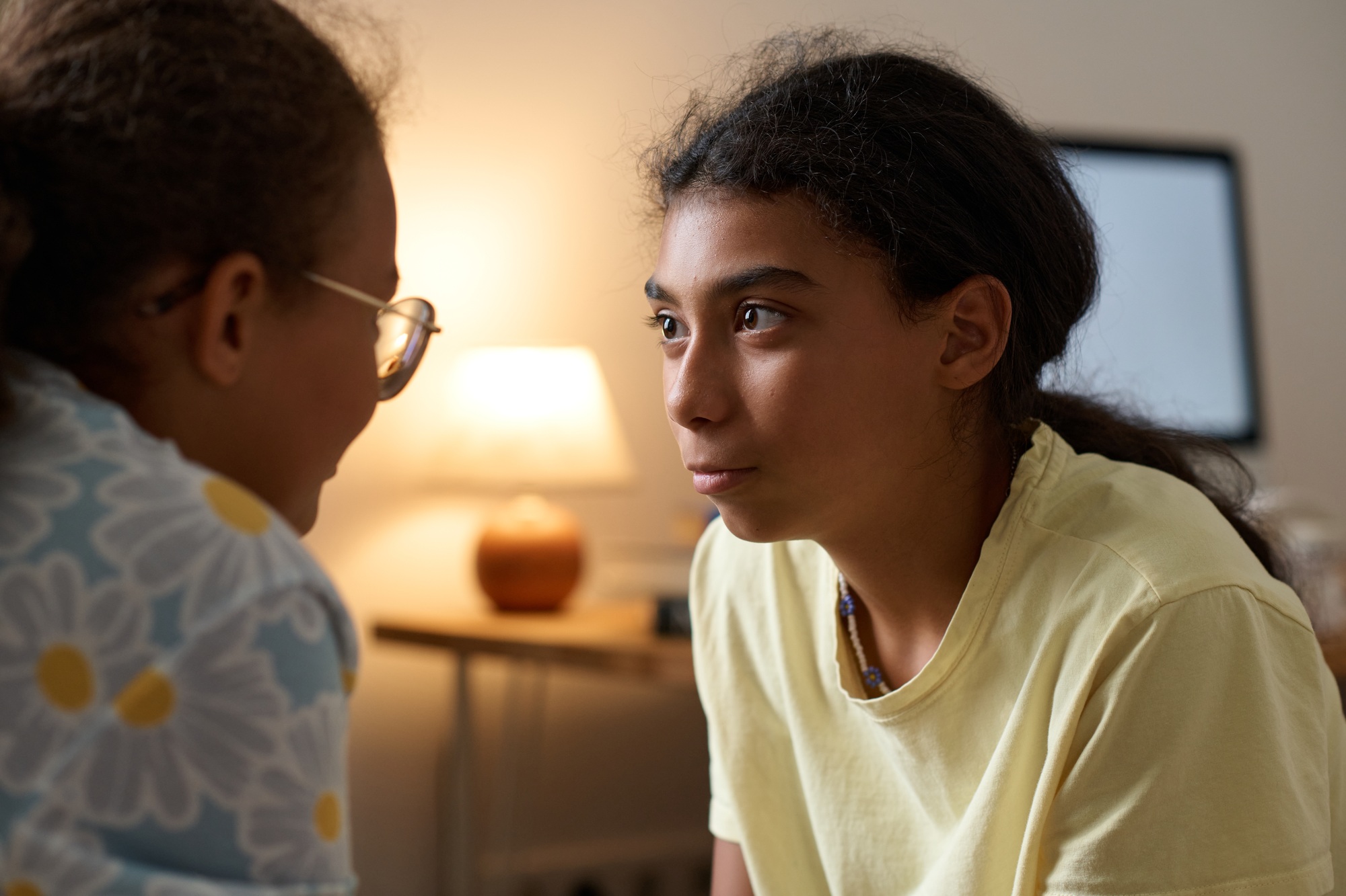 Elder sister talking to her young sister